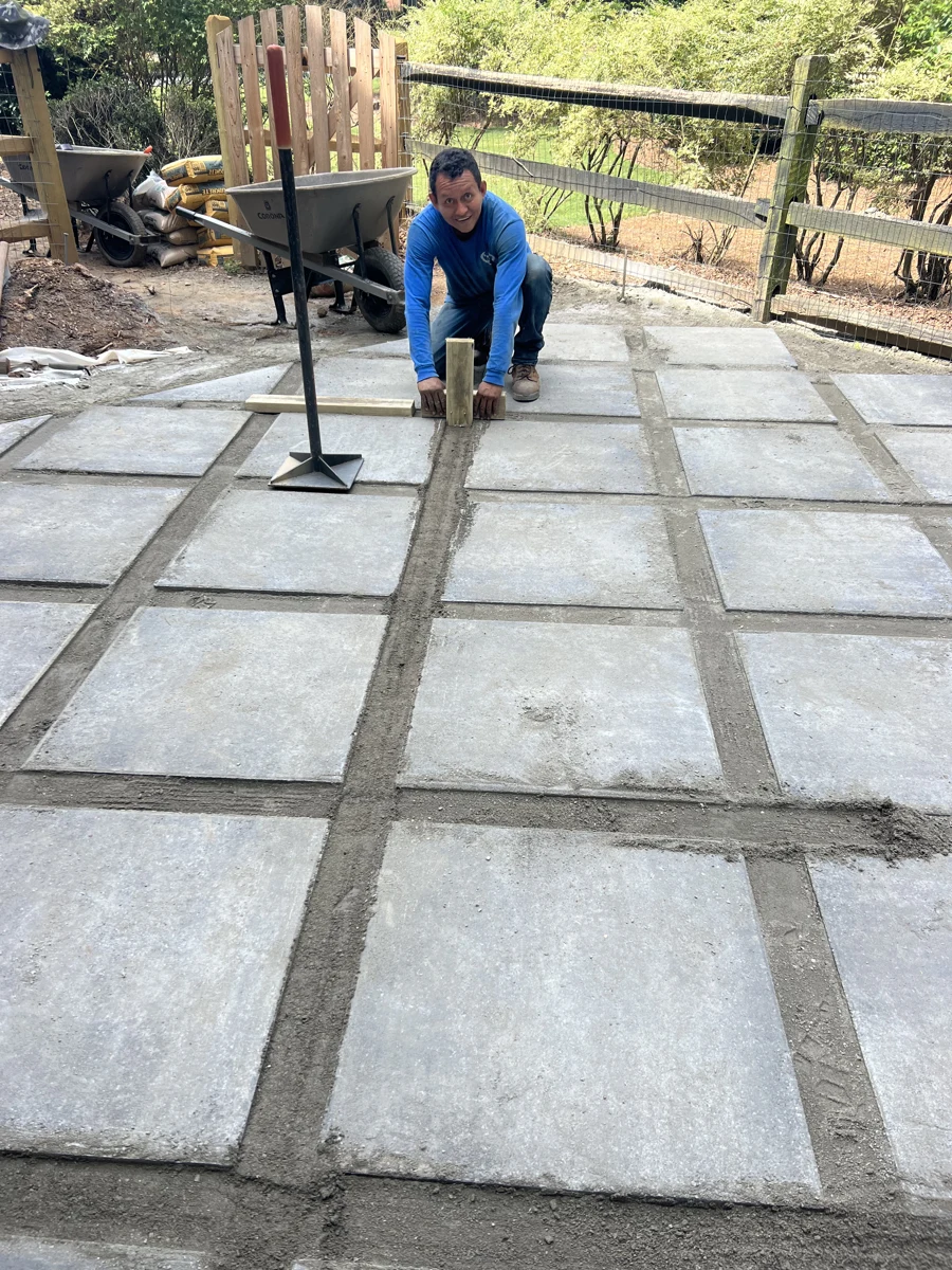 Professional installing geometric patio paving