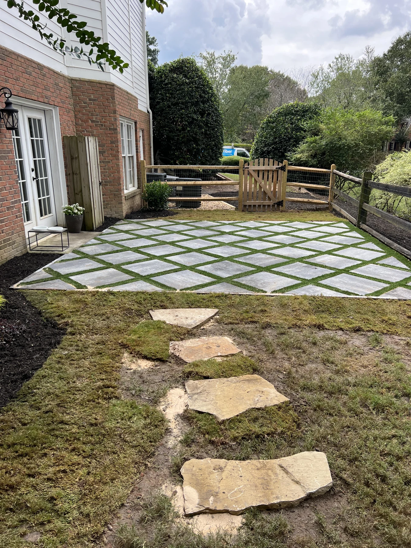 Finished geometric patio with stone paving and grass joints